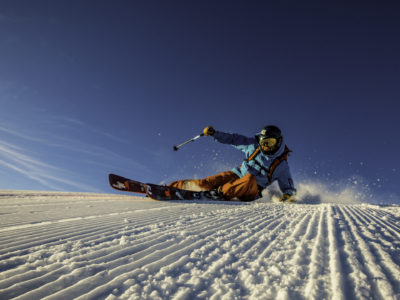 Skier carves on freshly groomed trail in Whistler Blackcomb. Skier carves on freshly groomed trail in Whistler Blackcomb.